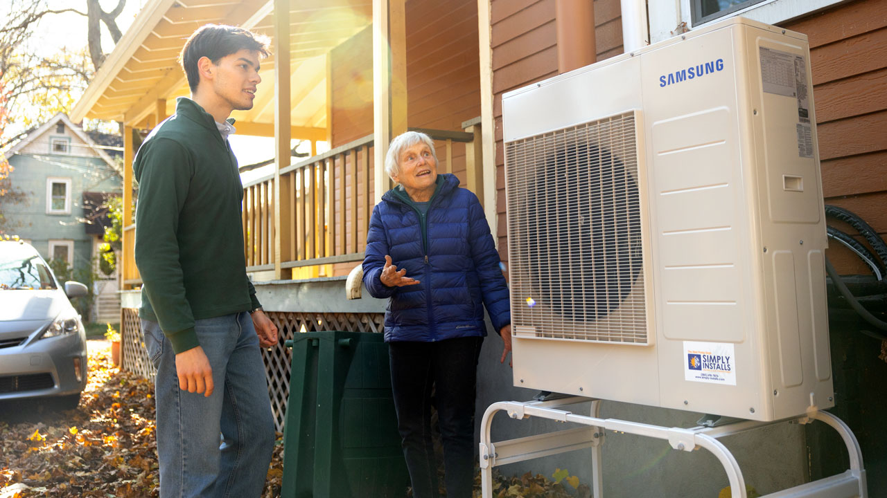 With Ithaca-based landlord and activist Ruth Yarrow, Kristinko Mato ’24 discusses a recently installed heat pump.