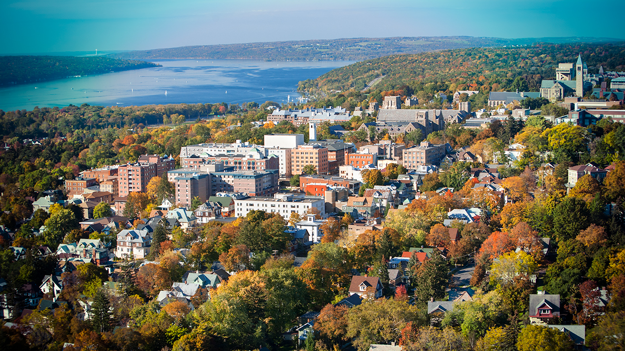 An aerial view in fall of central campus with Cayuga Lake in the background.