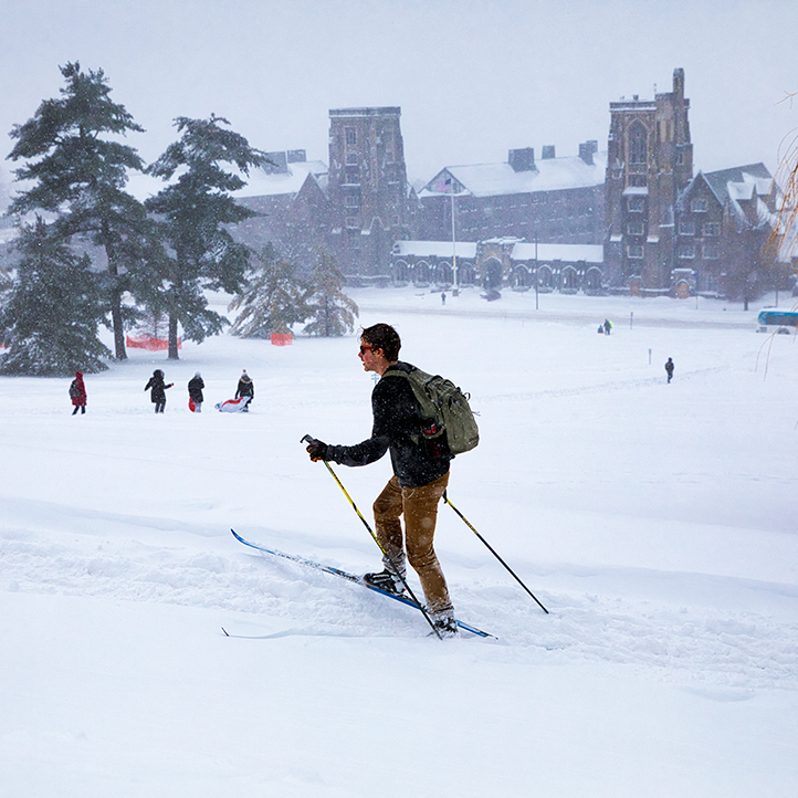 Student cross-country skiing on campus.