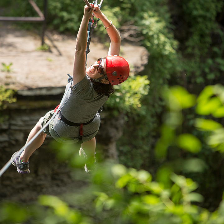 Woman tries out the zip line across Fall Creek Gorge.