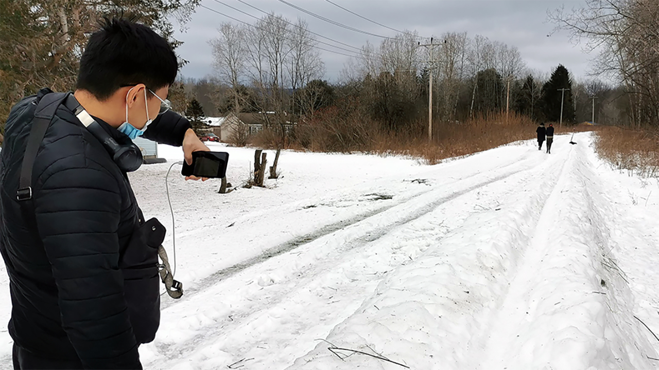 Tianzhen Jia of Mitch Glass's Landscape Architecture Sophomore Studio photographs a traditional snow snake course.