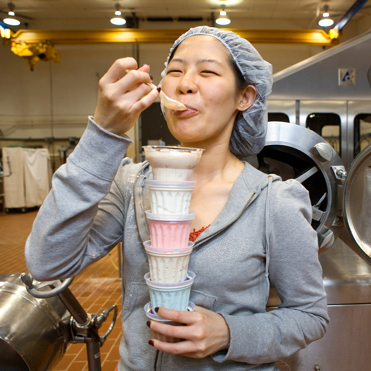 female student tests ice cream in lab